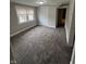 Bedroom featuring neutral walls, base trim, carpeted flooring and window at 733 Haugh St, Indianapolis, IN 46222