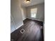 Bright bedroom with dark wood floors, neutral paint, and a window for natural light at 733 Haugh St, Indianapolis, IN 46222