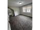 Bedroom featuring neutral walls, base trim, carpeted flooring and window at 733 Haugh St, Indianapolis, IN 46222