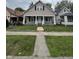 Charming home featuring a covered front porch with decorative columns and a well-maintained lawn at 733 Haugh St, Indianapolis, IN 46222