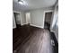 Inviting living room with new flooring, fresh paint, and access to the staircase at 733 Haugh St, Indianapolis, IN 46222