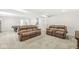 Spacious basement with comfortable brown leather couches and neutral carpeting at , Greenwood, IN 46143