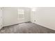 This bedroom features gray carpeting, a window, and white walls at , Greenwood, IN 46143