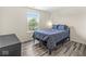 Cozy bedroom with a modern platform bed, wood floors, and natural light at , Greenwood, IN 46143