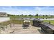 Outdoor deck space with a table, chairs, and grills overlooking a serene pond at , Greenwood, IN 46143