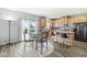 Sun-filled dining area with a kitchen, a table for four, and stainless steel appliances at , Greenwood, IN 46143
