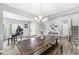 Open dining area features a long table, wood floors, and a decorative chandelier at , Greenwood, IN 46143