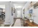 Hallway with wood floors, an antique table, and a view of the piano room and the entry door at , Greenwood, IN 46143