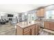 Kitchen island flowing into a cozy living area with a fireplace, and stainless steel appliances at , Greenwood, IN 46143