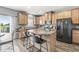 Open kitchen with an island, stainless steel appliances, wood cabinets and a view of the lake at , Greenwood, IN 46143
