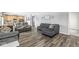 Bright living area featuring wood floors, gray sectional, and gray recliner chairs at , Greenwood, IN 46143