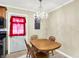 Bright dining room features a view of the kitchen and a classic chandelier at 7455 W 700 N, Fairland, IN 46126