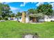 A quaint home boasts a covered front porch, a stone chimney, and a spacious green lawn at 7455 W 700 N, Fairland, IN 46126