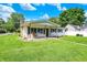 Inviting home featuring a cozy covered porch with wooden swing and well-manicured lawn at 7455 W 700 N, Fairland, IN 46126