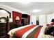 A view of the primary bedroom with wood floors, paneled doors, and a large, comfortable bed at 7455 W 700 N, Fairland, IN 46126