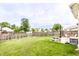 Spacious, fenced backyard featuring a lush lawn, fire pit, and patio with outdoor seating and picnic table at 7546 Kidwell Dr, Indianapolis, IN 46239