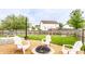 Outdoor living space featuring a fire pit, Adirondack chairs, and a large grassy yard at 7546 Kidwell Dr, Indianapolis, IN 46239