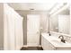 Bright bathroom featuring a double sink vanity, white cabinets and a bathtub with shower at 7546 Kidwell Dr, Indianapolis, IN 46239
