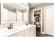 Well-lit bathroom with double sinks and access to a walk-in closet at 7546 Kidwell Dr, Indianapolis, IN 46239