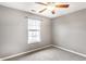 Comfortable bedroom featuring gray walls, carpeted floors, and a window at 7546 Kidwell Dr, Indianapolis, IN 46239