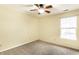 Cozy bedroom with neutral carpet, a ceiling fan, and a bright window view at 7546 Kidwell Dr, Indianapolis, IN 46239