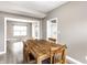 Dining room with wood table set and views into the living room and kitchen at 7546 Kidwell Dr, Indianapolis, IN 46239