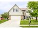 Charming two-story home with a well-manicured lawn and attached two-car garage at 7546 Kidwell Dr, Indianapolis, IN 46239
