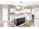 Bright kitchen with white cabinets, modern appliances, and a contrasting kitchen island at 7546 Kidwell Dr, Indianapolis, IN 46239