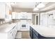 Bright kitchen with white cabinets, modern appliances, and a contrasting kitchen island at 7546 Kidwell Dr, Indianapolis, IN 46239