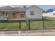 Backyard with a wooden deck, black chainlink fence, and green grass at 824 Ashton Park Dr, Greenwood, IN 46143