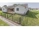 Backyard with a wooden deck, black chainlink fence, and green grass at 824 Ashton Park Dr, Greenwood, IN 46143