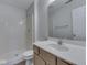 Bathroom features a vanity, mirror, and a shower with white tile surround at 824 Ashton Park Dr, Greenwood, IN 46143