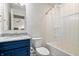 Cozy bathroom featuring a shower over tub with shower curtain and blue vanity at 8635 Verbena Rd, Zionsville, IN 46077