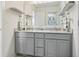 Bright bathroom featuring a double sink vanity with granite countertop at 8635 Verbena Rd, Zionsville, IN 46077