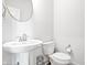 Bright half bathroom featuring a pedestal sink at 8635 Verbena Rd, Zionsville, IN 46077