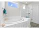 Bright bathroom featuring a soaking tub and glass enclosed shower at 8635 Verbena Rd, Zionsville, IN 46077