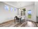 Bright dining room with modern table and chairs, ample natural light, and backyard access at 8635 Verbena Rd, Zionsville, IN 46077