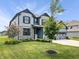Well-kept home with a lush green lawn, mature trees, and a two-car garage at 8635 Verbena Rd, Zionsville, IN 46077