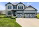 Beautiful two-story home featuring a well-manicured lawn, and a two-car garage at 8635 Verbena Rd, Zionsville, IN 46077