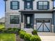 Home featuring a stone facade, a covered front porch, and landscaped flower beds at 8635 Verbena Rd, Zionsville, IN 46077