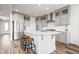 Kitchen featuring a large island with bar seating, stainless steel appliances and gray cabinetry at 8635 Verbena Rd, Zionsville, IN 46077