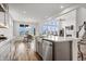 Open-concept kitchen with stainless steel appliances, large island, and views into the dining and living spaces at 8635 Verbena Rd, Zionsville, IN 46077