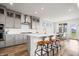 Spacious kitchen with stainless steel appliances, subway tile backsplash, and a large center island with seating at 8635 Verbena Rd, Zionsville, IN 46077
