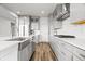 Open kitchen featuring stainless steel appliances, white cabinetry, and an island sink at 8635 Verbena Rd, Zionsville, IN 46077