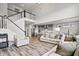 Bright living room with staircase overlooking the open floor plan to kitchen and dining area at 8635 Verbena Rd, Zionsville, IN 46077