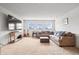 Bright living room with a large sectional couch, guitars, and a modern TV console at 8635 Verbena Rd, Zionsville, IN 46077