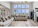 Inviting living room featuring large windows, hardwood floors, and comfortable furniture at 8635 Verbena Rd, Zionsville, IN 46077