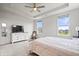 Bright main bedroom features neutral colors, a ceiling fan, and dual windows letting in natural light at 8635 Verbena Rd, Zionsville, IN 46077