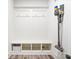 Mudroom with built-in storage bench, hooks, and a convenient vacuum cleaner mount at 8635 Verbena Rd, Zionsville, IN 46077