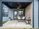 Cozy outdoor patio with comfortable seating, ceiling fan, and a pizza oven on a stand at 8635 Verbena Rd, Zionsville, IN 46077